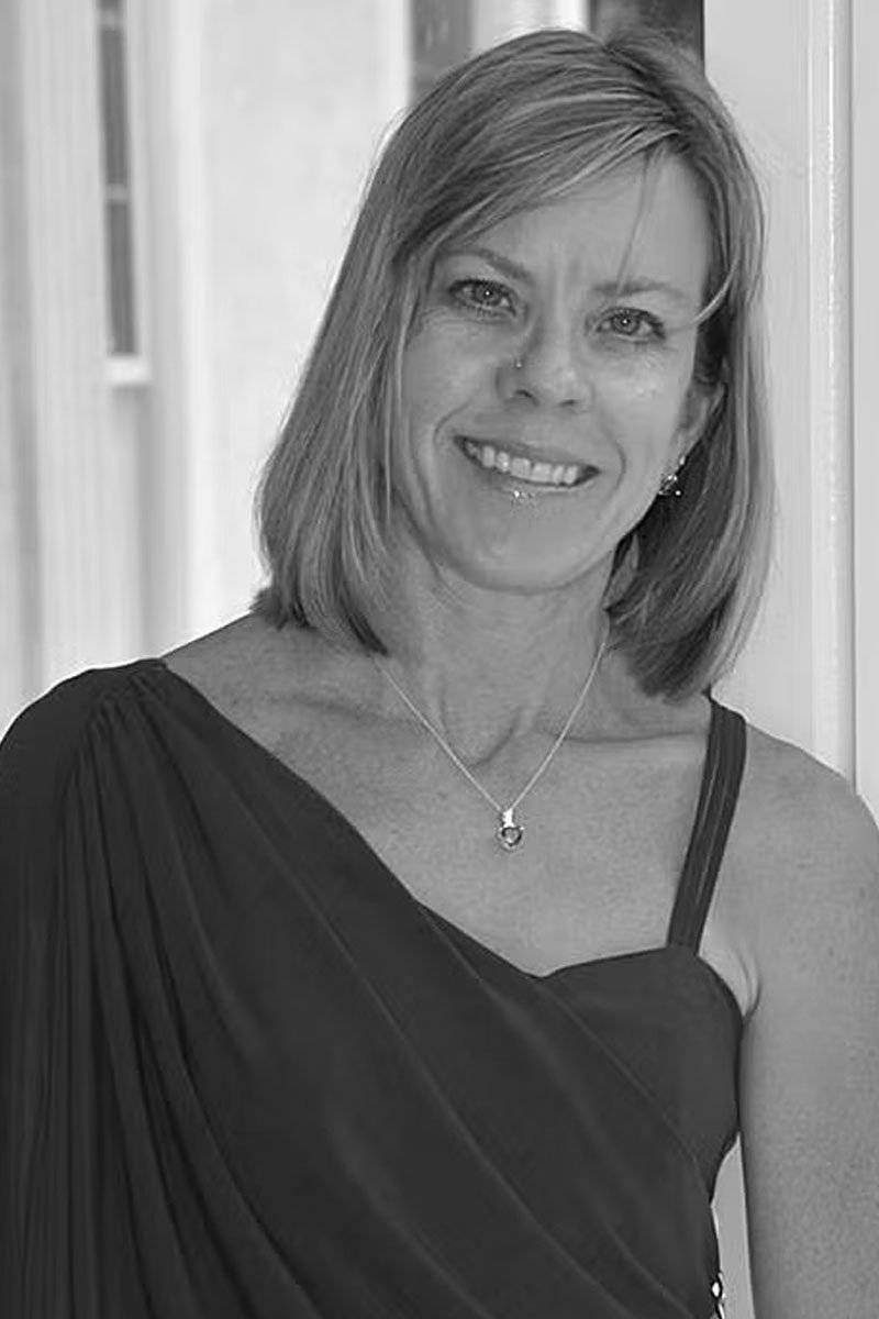 A black and white photo of a female photographer from Candid Studios, photography and videography