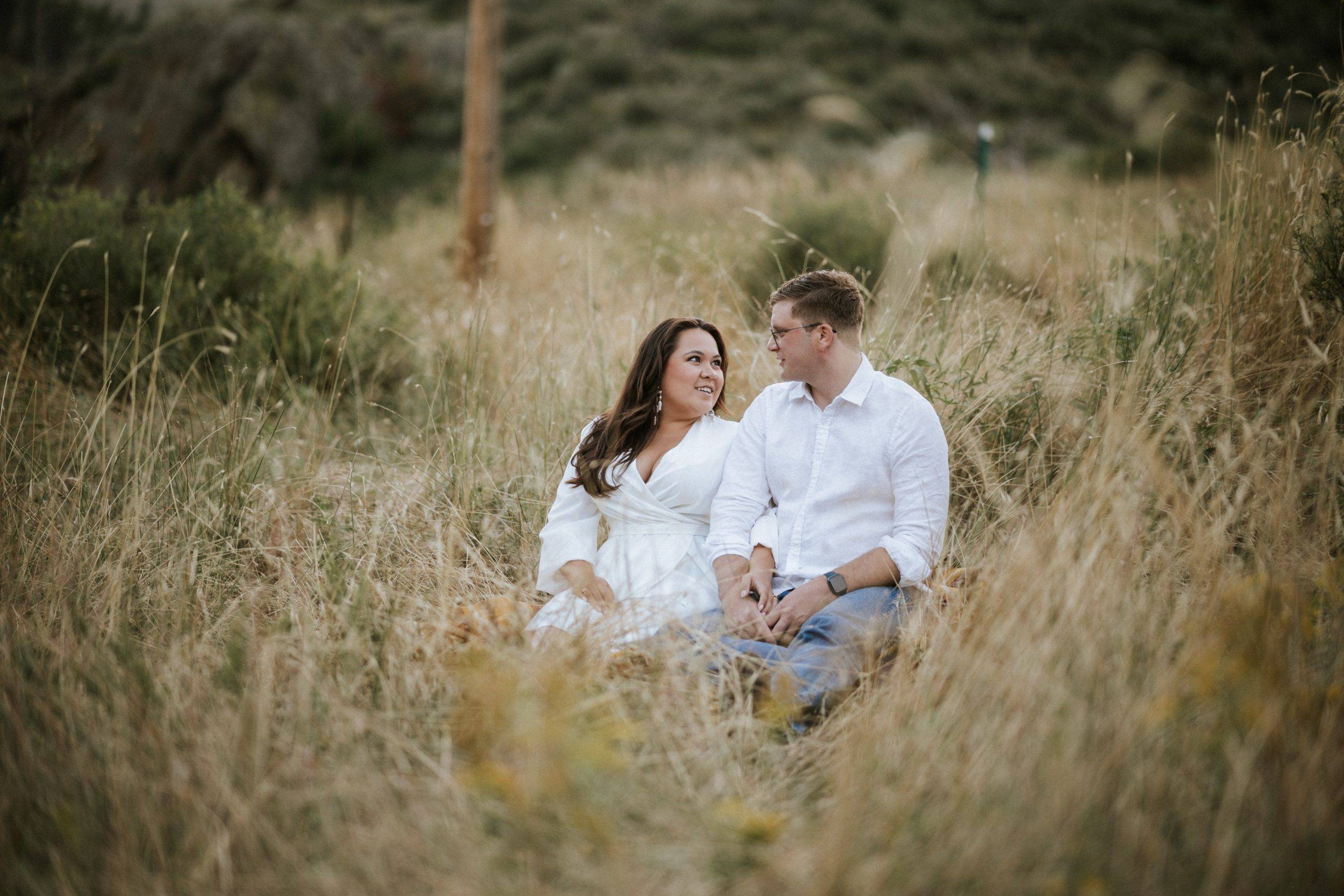 Couples engagement shoot in tall grasses in Colorado