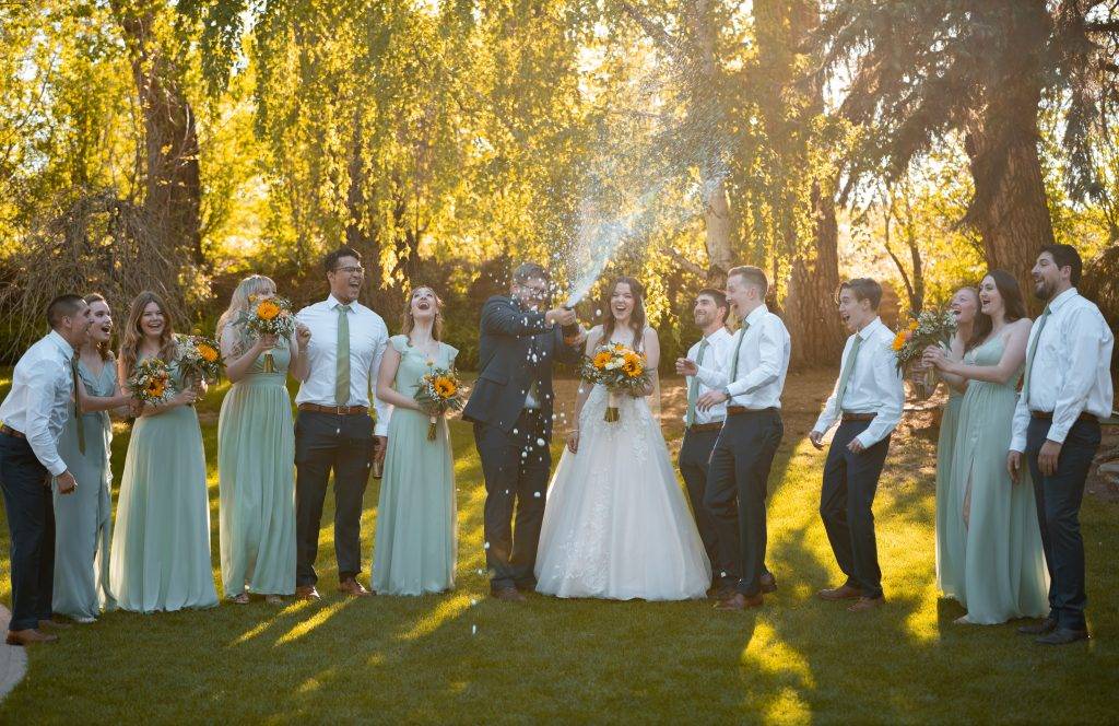 Bridal party popping champagne with the wedding party in Denver Colorado