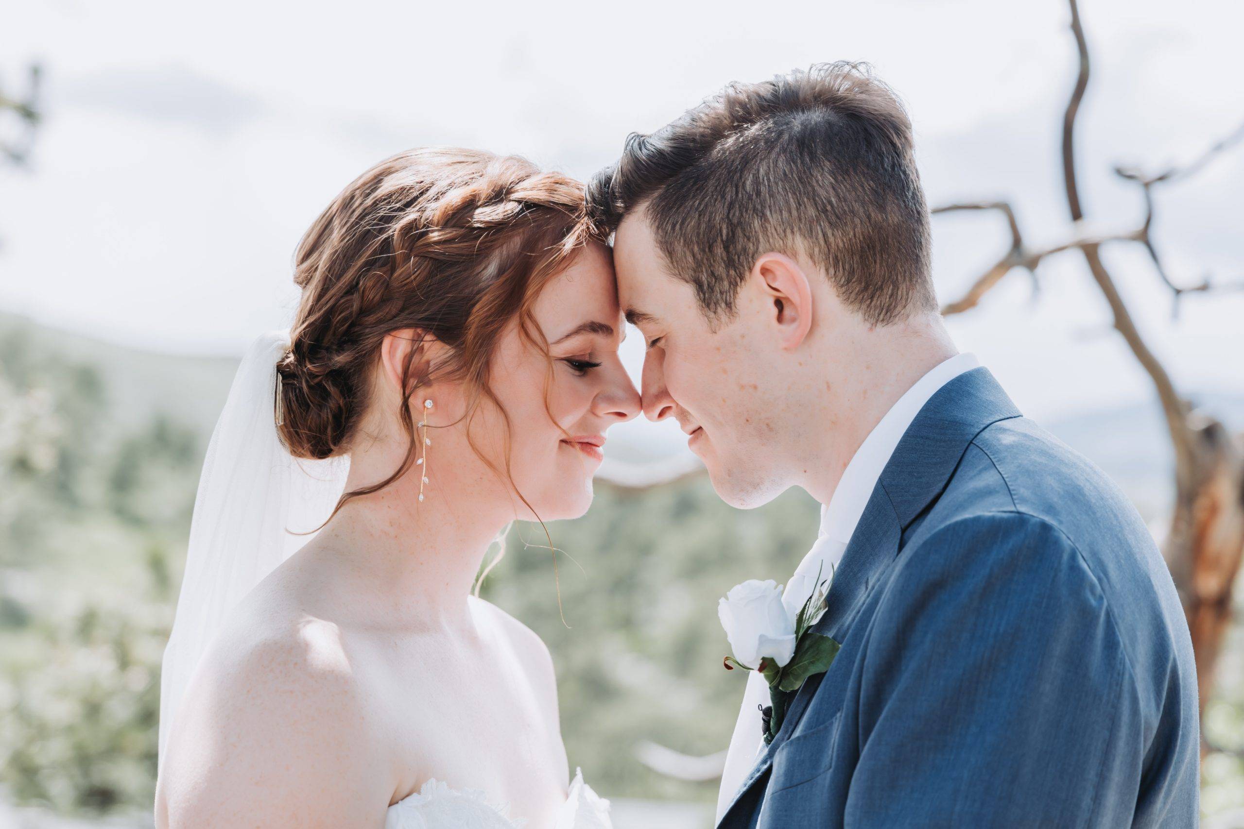 A bride and groom named Jessica and Keith touching foreheads at a Colorado wedding