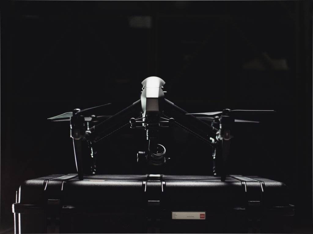 The DJI inspire 2 aerial drone to sitting on a heard case in a dark room