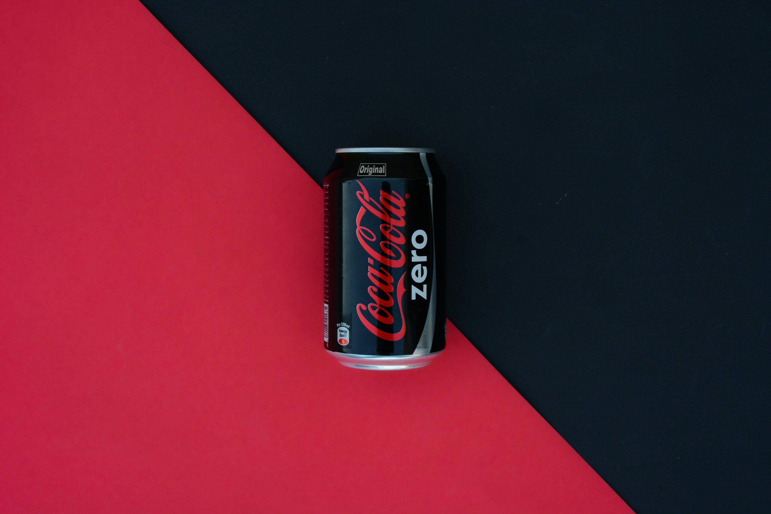 product photography of a coca cola zero on a black and red background