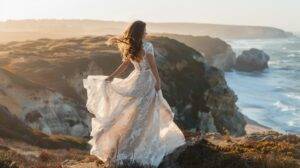 A happy bride twirls in a lace wedding dress on a beautiful coastal cliff.A happy bride twirls in a lace wedding dress on a beautiful coastal cliff.
